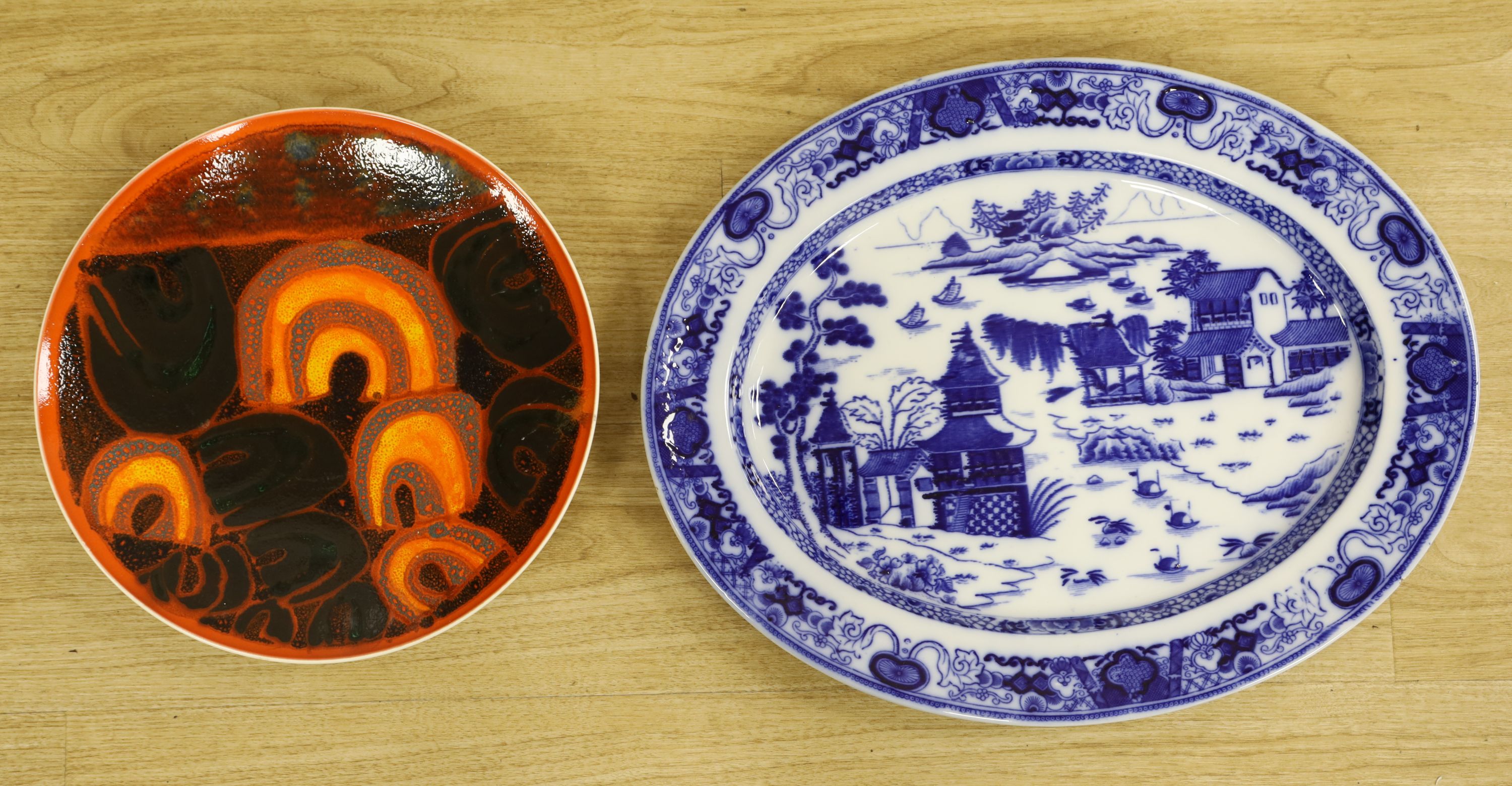 A Poole pottery charger and a blue and white oval Ashworth dish, length 55cm